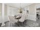 Bright dining area with modern light fixture and large windows, perfect for hosting gatherings and Gathering meals at 140 Sanford Ln, Badin Lake, NC 28127