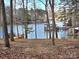 Tranquil lake view framed by trees, showcasing the area's natural beauty and offering peaceful vibes at 140 Sanford Ln, Badin Lake, NC 28127