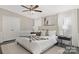 Serene main bedroom with neutral tones, hardwood floors, and ample natural light, creating a peaceful retreat at 140 Sanford Ln, Badin Lake, NC 28127