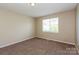 This bedroom features neutral paint, a window for natural light, and cozy carpet flooring at 1569 Brentfield Dr, Rock Hill, SC 29732