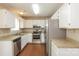 The kitchen is equipped with stainless steel appliances, white cabinetry, and granite countertops at 1569 Brentfield Dr, Rock Hill, SC 29732