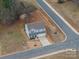 Aerial view of a two-story home showcasing the roof, driveway, and surrounding lawn at 1587 Berkshire Dr, Newton, NC 28658