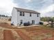 Spacious backyard with a concrete patio, planting beds, and a slide at 1587 Berkshire Dr, Newton, NC 28658