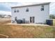 Backyard of a two-story house with a concrete patio, planting beds, and an outdoor grill at 1587 Berkshire Dr, Newton, NC 28658