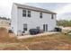 A two-story home with a backyard featuring a concrete patio and planting beds at 1587 Berkshire Dr, Newton, NC 28658