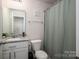 Clean bathroom featuring a granite vanity, neutral tones, and a shower-tub combination for functionality and comfort at 1587 Berkshire Dr, Newton, NC 28658