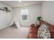 Neutral bedroom offers a leather couch, play tent and natural light from a window view at 1587 Berkshire Dr, Newton, NC 28658