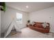 Neutral bedroom offers a leather couch, play tent and natural light from a window view at 1587 Berkshire Dr, Newton, NC 28658