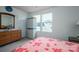 Bright bedroom with neutral walls, a window for natural light, and a dresser with a large mirror at 1587 Berkshire Dr, Newton, NC 28658