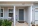Inviting front entrance featuring a gray door, 'Welcome' sign, and landscaped accents at 1587 Berkshire Dr, Newton, NC 28658