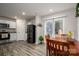 Open-concept kitchen and dining area with stainless steel appliances, a breakfast bar, and access to outdoor space at 1587 Berkshire Dr, Newton, NC 28658