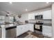 Bright kitchen with stainless steel appliances, granite countertops, and adjacent living area for open-concept living at 1587 Berkshire Dr, Newton, NC 28658