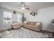 Inviting living room with a neutral palette, ceiling fan, and patterned rug, perfect for relaxing and entertaining at 1587 Berkshire Dr, Newton, NC 28658