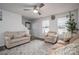 Cozy living room with neutral-toned furniture, a ceiling fan, and plenty of natural light at 1587 Berkshire Dr, Newton, NC 28658