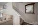 Staircase leading to the upper level, featuring a neutral color scheme, carpeted steps, and a decorative mirror at 1587 Berkshire Dr, Newton, NC 28658