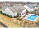 Aerial view of a lovely home with a fenced backyard, in-ground pool, and patio area at 162 Pecan Hills Dr, Mooresville, NC 28115