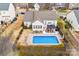 A sparkling blue pool with a surrounding patio and gazebo for outdoor enjoyment at 162 Pecan Hills Dr, Mooresville, NC 28115