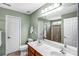 Bathroom with a double vanity sink, large mirror, and a tiled shower at 162 Pecan Hills Dr, Mooresville, NC 28115