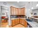 Functional kitchen featuring tile backsplash, wood cabinets, and granite countertops at 162 Pecan Hills Dr, Mooresville, NC 28115