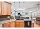 Kitchen with granite countertops and wood cabinets open to the living room and dining area at 162 Pecan Hills Dr, Mooresville, NC 28115