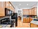 Well-equipped kitchen featuring wooden cabinets, granite countertops, and modern appliances at 162 Pecan Hills Dr, Mooresville, NC 28115