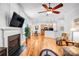 Open concept living space with kitchen view, hardwood floors, and fireplace at 162 Pecan Hills Dr, Mooresville, NC 28115