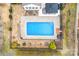 Aerial view of a private in-ground pool surrounded by patio, landscaping, and a gazebo-covered seating area at 162 Pecan Hills Dr, Mooresville, NC 28115