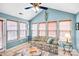 Bright sunroom with large windows, vaulted ceiling, and comfortable seating area at 162 Pecan Hills Dr, Mooresville, NC 28115