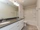 Bathroom with double vanity, gray countertops, and white cabinets; tiled floor and tub-shower combination at 16725 Cozy Cove Rd, Charlotte, NC 28278