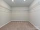 Empty walk-in closet with wire shelving and neutral carpet at 16725 Cozy Cove Rd, Charlotte, NC 28278