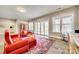 Bright living room with comfortable red seating, bookcase and sliding glass doors to the outdoors at 17927 Culross Ln, Charlotte, NC 28278