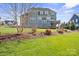 Expansive backyard with lush green lawn, mature trees, and rear deck stairway at 190 Hidden Meadows Dr, Mooresville, NC 28117