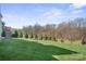 Beautiful backyard featuring a large green lawn and mature trees, creating a private outdoor space at 190 Hidden Meadows Dr, Mooresville, NC 28117