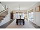 Bright dining area featuring a chandelier, large windows, and stairway nearby at 190 Hidden Meadows Dr, Mooresville, NC 28117