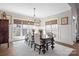 Elegant dining room with large windows, stylish chandelier, and seating for six guests at 190 Hidden Meadows Dr, Mooresville, NC 28117