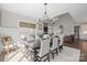Open dining area with a view to the living room, fireplace, and an outdoor living space at 190 Hidden Meadows Dr, Mooresville, NC 28117