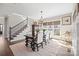 Dining area featuring a modern chandelier, large windows, and a staircase at 190 Hidden Meadows Dr, Mooresville, NC 28117