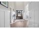 Welcoming home entryway with hardwood floors, decorative wreath on the front door, and elegant trim at 190 Hidden Meadows Dr, Mooresville, NC 28117