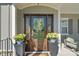 Close-up of the front door adorned with a wreath and flanked by potted flowers at 190 Hidden Meadows Dr, Mooresville, NC 28117