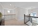 Hallway with contemporary chandelier and railing at 190 Hidden Meadows Dr, Mooresville, NC 28117