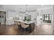 Elegant kitchen featuring a large island with seating, white cabinetry, and pendant lighting at 190 Hidden Meadows Dr, Mooresville, NC 28117