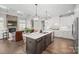 Modern kitchen with stainless steel appliances, large island, pendant lighting, and open concept to the living area at 190 Hidden Meadows Dr, Mooresville, NC 28117