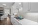 Bright kitchen features white cabinets, modern appliances, and a view of a fireplace and living area at 190 Hidden Meadows Dr, Mooresville, NC 28117