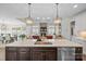 Open-concept kitchen with a large island, stainless steel appliances, and open layout to the living room at 190 Hidden Meadows Dr, Mooresville, NC 28117