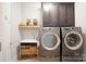 Well-equipped laundry room with modern washer, dryer, utility sink, and storage cabinets at 190 Hidden Meadows Dr, Mooresville, NC 28117