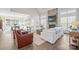 Spacious living room with a stone fireplace, bright windows, and comfortable seating arrangement at 190 Hidden Meadows Dr, Mooresville, NC 28117