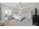 Serene main bedroom features tray ceilings, neutral decor, and carpeted flooring at 190 Hidden Meadows Dr, Mooresville, NC 28117