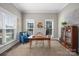 Bright office with hardwood floors, natural light, cozy seating, and a beautiful bookshelf at 190 Hidden Meadows Dr, Mooresville, NC 28117