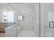 Modern shower with glass enclosure, tiled walls, and built-in bench at 190 Hidden Meadows Dr, Mooresville, NC 28117