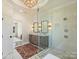 Spacious bathroom features a glass shower, double vanities, and a patterned rug on the tile floor at 2004 Lombardy Cir, Charlotte, NC 28203